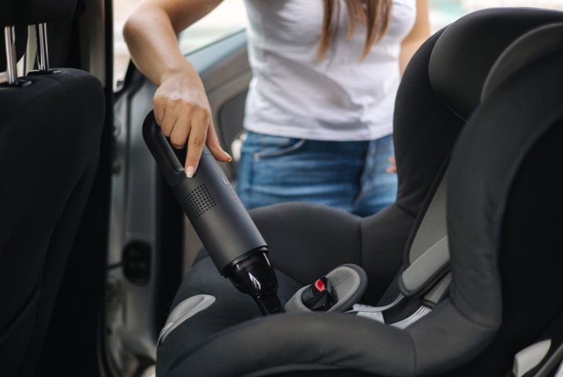 Vacuuming the crumbs when cleaning car seat