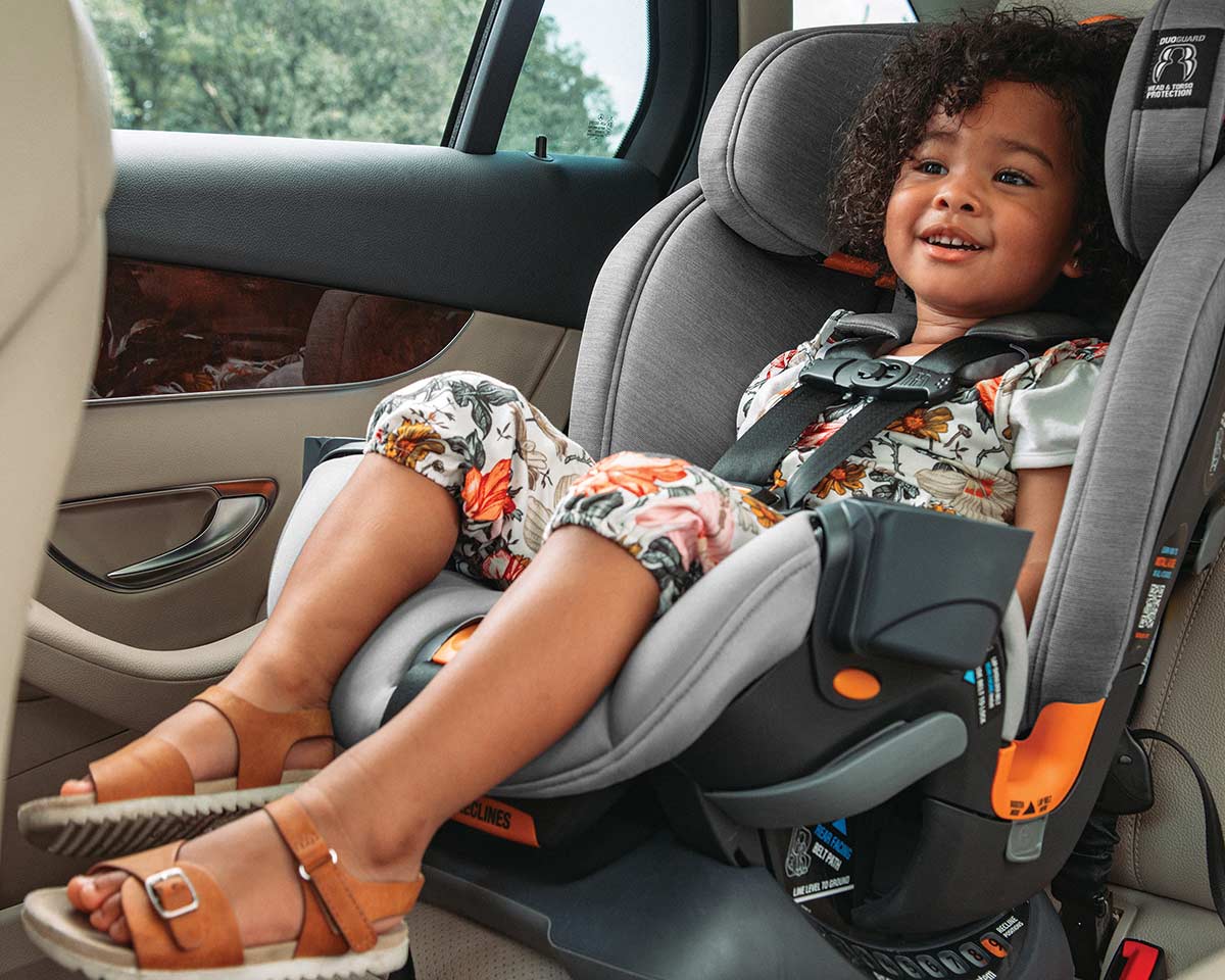 Child seated comfortably in a Chicco all-in-one car seat inside a vehicle