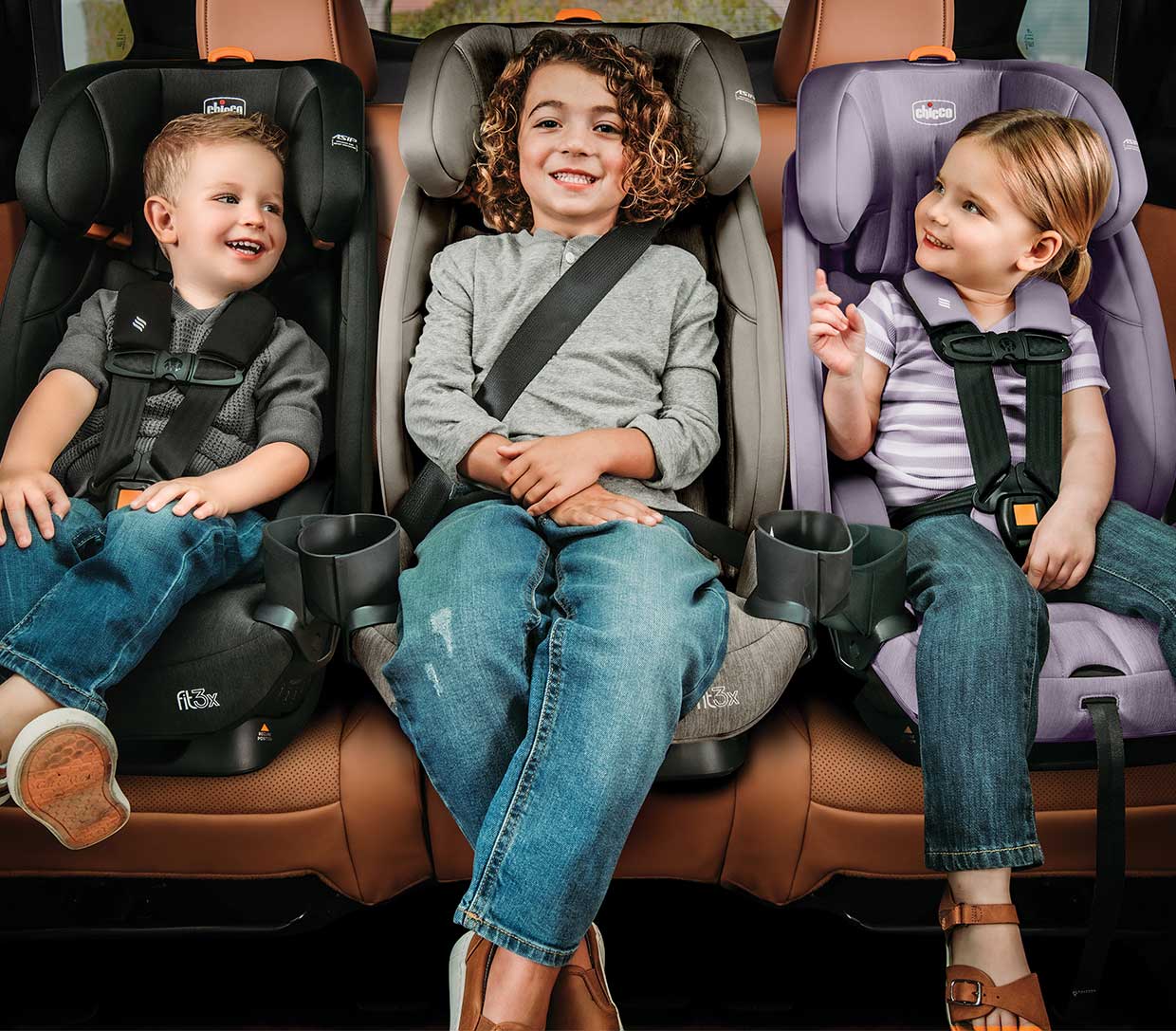 Three Chicco Fit3x ClearTex car seats with children image