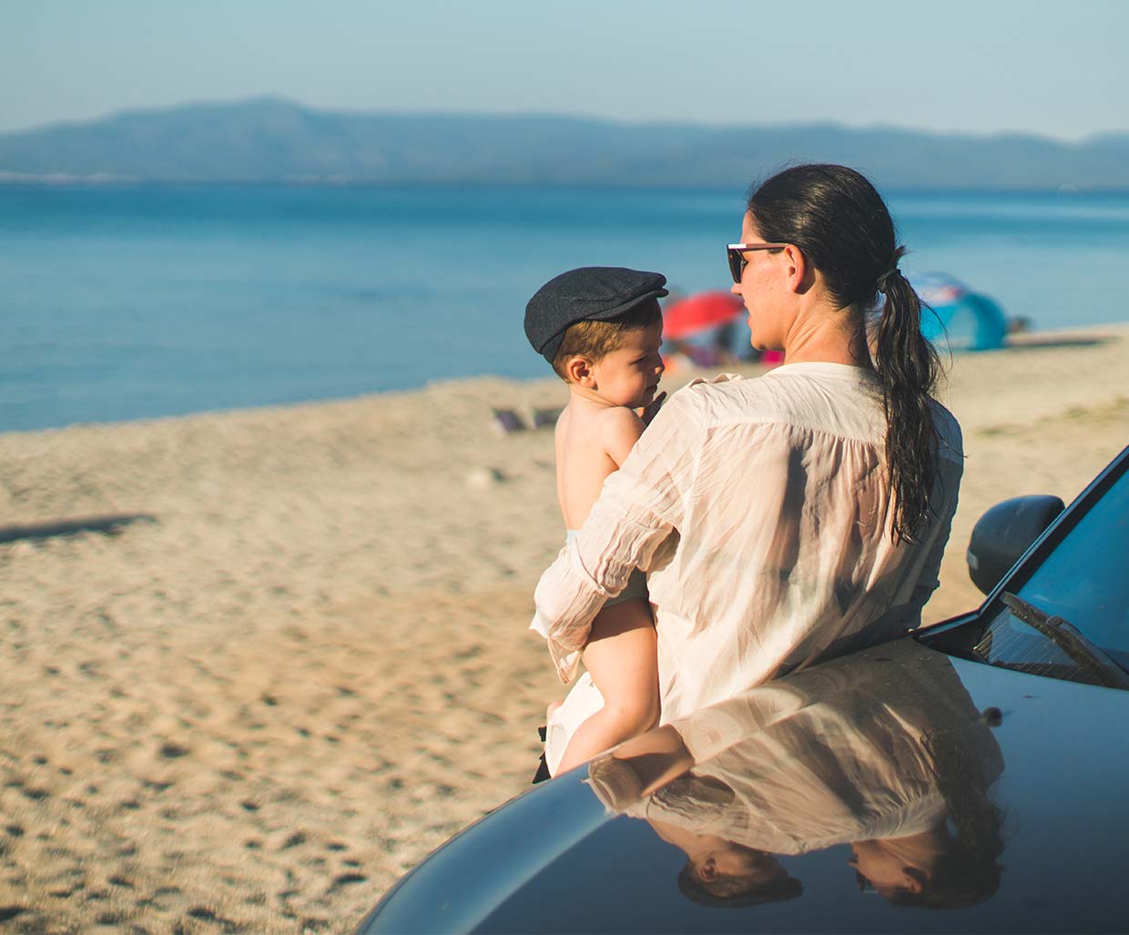 Mom and Baby at beach on family road trip image